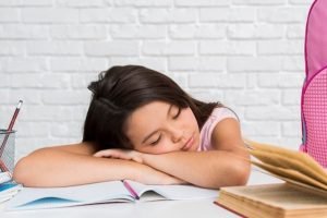 child resting on desk